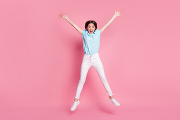 Canvas Print - Full length photo of crazy carefree girl jump raise hands isolated over pink color background