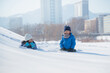 © lalalululala - Happy Asian children lying on snow together in the park