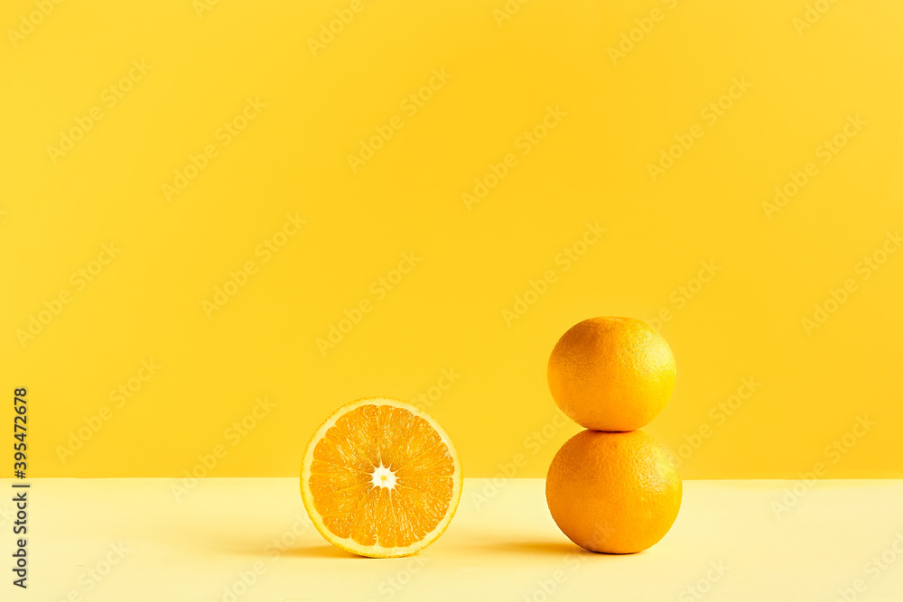Obraz na płótnie Citrus fruit orange on yellow background. Art trendy minimalist still life. Healthy lifestile. Vitamin C. w salonie