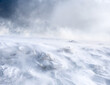 A mountain slope covered with a layer of snow during strong winds. Trapped in motion.
