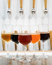 Different Types Of Beer Displayed In Wine Glasses