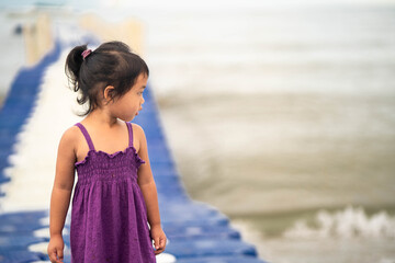 Wall Mural - Cute little girl walking on Modular Plastic Floating Dock