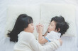 © lalalululala - Cute asian children lying on white bed
