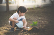 © lalalululala - Cute Asian child watering young tree