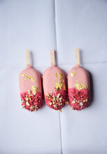 Three Pink Ice Cream Sticks With Gold Leaf