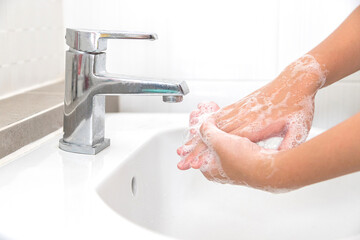 Wall Mural - Washing your hands with soap for cleaning helps prevent germs