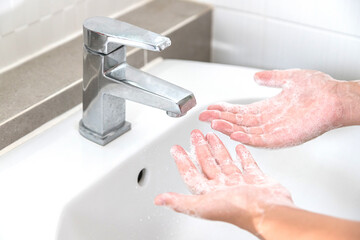 Wall Mural - Washing your hands with soap for cleaning helps prevent germs