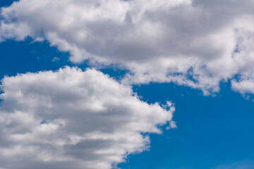 Wall Mural - The blue sky is rich in color in clear weather with beautiful lush clouds. The beauty of nature in the fresh air, the layer of atmosphere visible to the eye from bottom to top