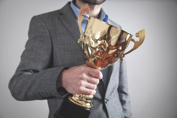 Wall Mural - Businessman holding golden trophy. Business, Success