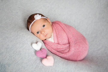 closeup portrait of cute newborn caucasian baby. adorable funny infant child with dark gray eyes and