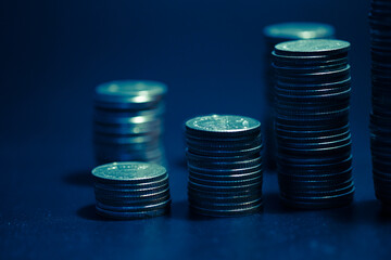 rows of coins and blurred bokeh for finance and banking concept