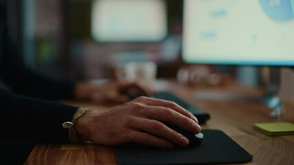 Wall Mural - close up on male hands of a specialist working on desktop computer in a busy creative office environ