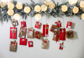 Sticker - Christmas Advent calendar with gifts and decor hanging on light wall