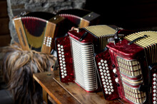 Hemsedal,Norway,08 September 2015 Group Of Traditional Norwegian Music Instruments Staying On Table With Rustic Stone Wall On Background,classic Red Accordion(bayan),scandinavian Folk Hobby