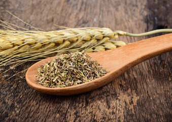 Wall Mural - Oregano in wood spoon on wooden