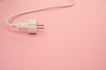 Sticker - High angle shot of an electrical wire and plug on a pink surface