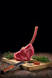 © boomeart - Raw juicy cowboy steak on wooden cutting board with spice