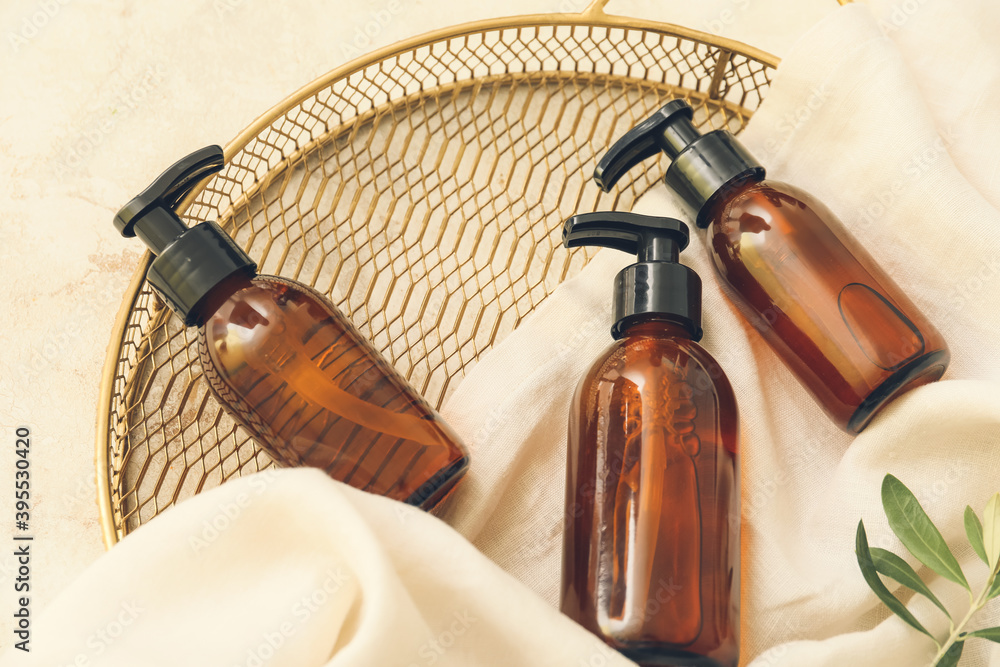 Cosmetic dispenser bottles on light background