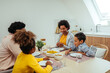 © bernardbodo - Cute afro family having lunch together at home