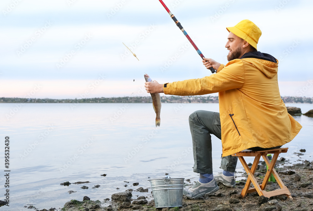 Young man fishing on river