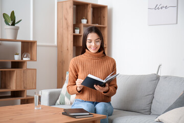 Sticker - Young woman reading book at home