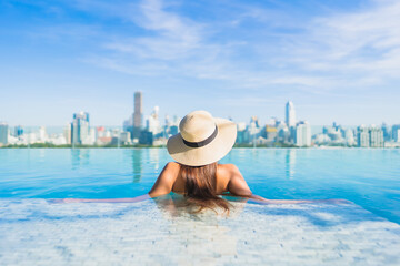 Portrait beautiful young asian woman smile relax leisure around outdoor swimming pool