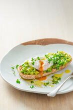 Poached Egg On Ciabatta Toast With Smashed Avocado, Cress And Olive Oil
