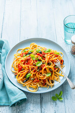 Spaghetti Puttanesca With Olives, Capers, Tomatoes, Chilli Flakes And Fresh Basil
