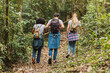 © René Stevens - Friends with backpacks walking in the countryside - Group of walking friends walking in the jungle.