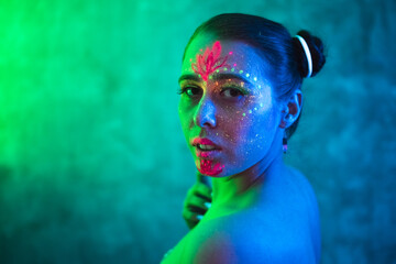 beautiful woman with body art glowing in ultraviolet light. ethnic, esoteric and fantasy concept. po