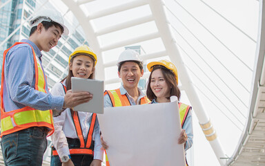 Group of engineer discussing about their construction project outside