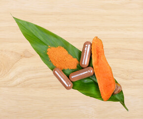 Wall Mural - Turmeric Root Powder on wood, Curcuma Root, Turmeric Capsule on Leaf; white background.Herb high vitamin C.