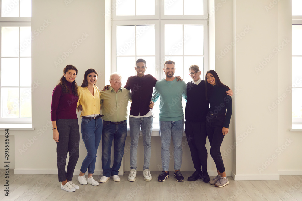 Group portrait by the window of happy positive diverse people of ...