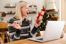 Surprised Woman Holding Credit Card And Gift