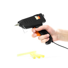 Hand Holding A Glue Gun. Close Up. Isolated On A White Background