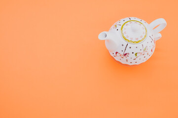 Sticker - Top view of teapot isolated on an orange background