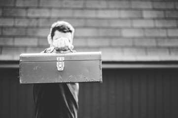 Sticker - Grayscale shot of a technician holding a toolbox