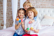© Maxim - Easter children portrait, funny emotions, surprise. Children, a girl and two boys hold Easter eggs in their hands. Funny photo. Adorable kid in colored clothes enjoying holiday