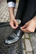 Cropped Image Of Businessman Tying His Shoe Outside