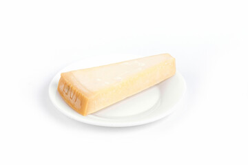 Sticker - Closeup of a piece of parmesan cheese on a plate isolated on a white background