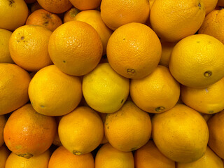 Many fresh oranges fruits. oranges on the market. oranges in a row