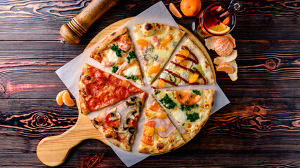 different pizza slices on a wooden table mix