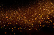 Beautiful, sparkling golden glitter pouring down from above on a dark background