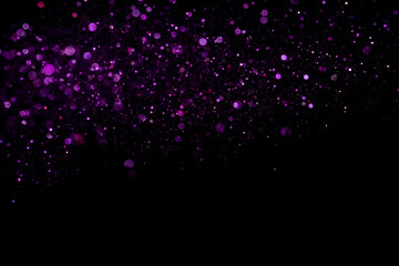 Beautiful, sparkling purple glitter pouring down from above on a dark background