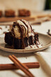 Closeup of a freshly baked delicious pumpkin chocolate brownie with ice cream on a plate