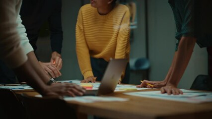 Aufkleber - Close Up of Diverse Multiethnic Team Having Conversation in Meeting Room in a Creative Office. Colleagues Lean On a Conference Table, Look at Laptop Computer and Make Notes with Pencils on Notebooks.