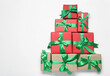 © New Africa - Christmas tree shape of gift boxes on white background, flat lay. Space for text