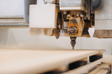 Closeup shot of an industrial plywood carving machine at work