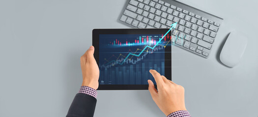 Business plan graph growth  increase of chart positive indicators in his business,tablet in hand