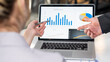 © ArLawKa - A group of confident young business professionals who analyze graph data using computers while spending time in their offices.